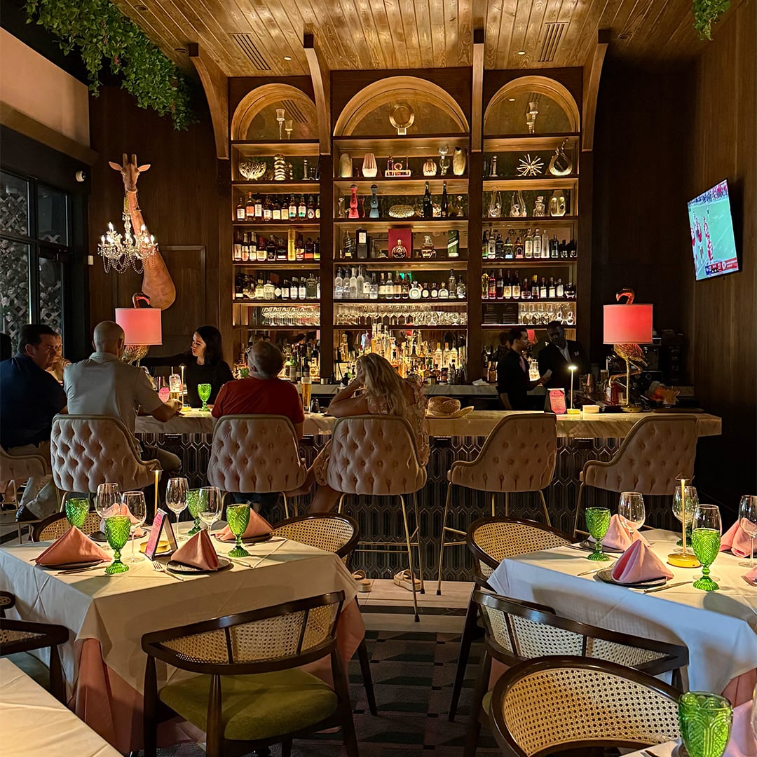 Pink Steak interior — glamorous pink-hued dining room with wrap-around bar